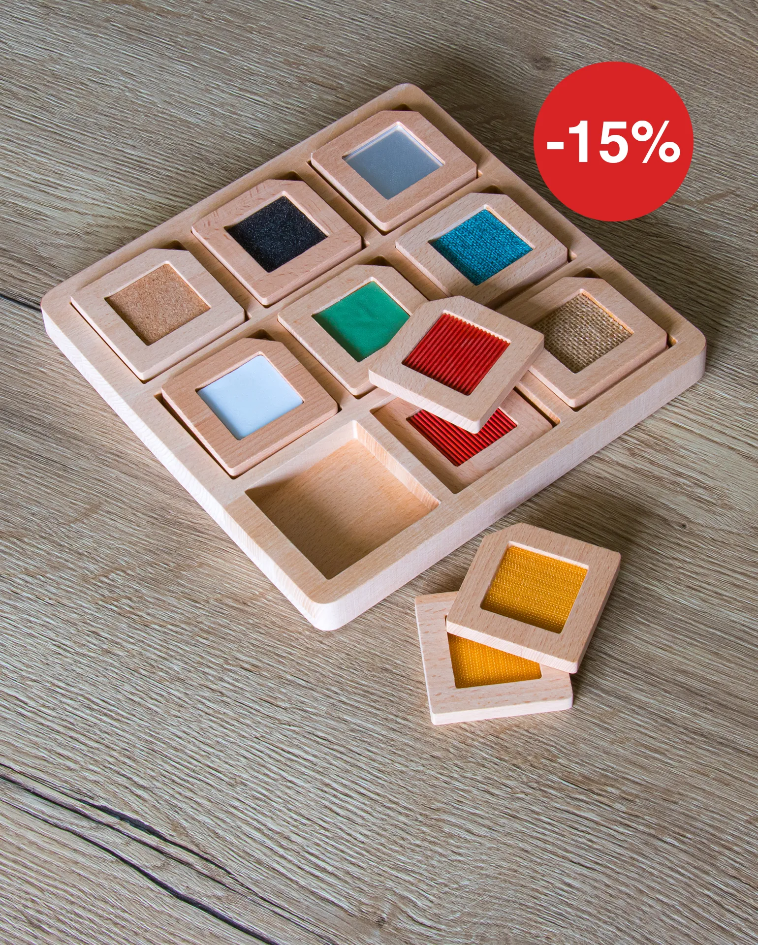 Kleine Holzkarten mit unterschiedlichen Materialien und Farben im Kern der Karte liegen in einem Holzrahmen